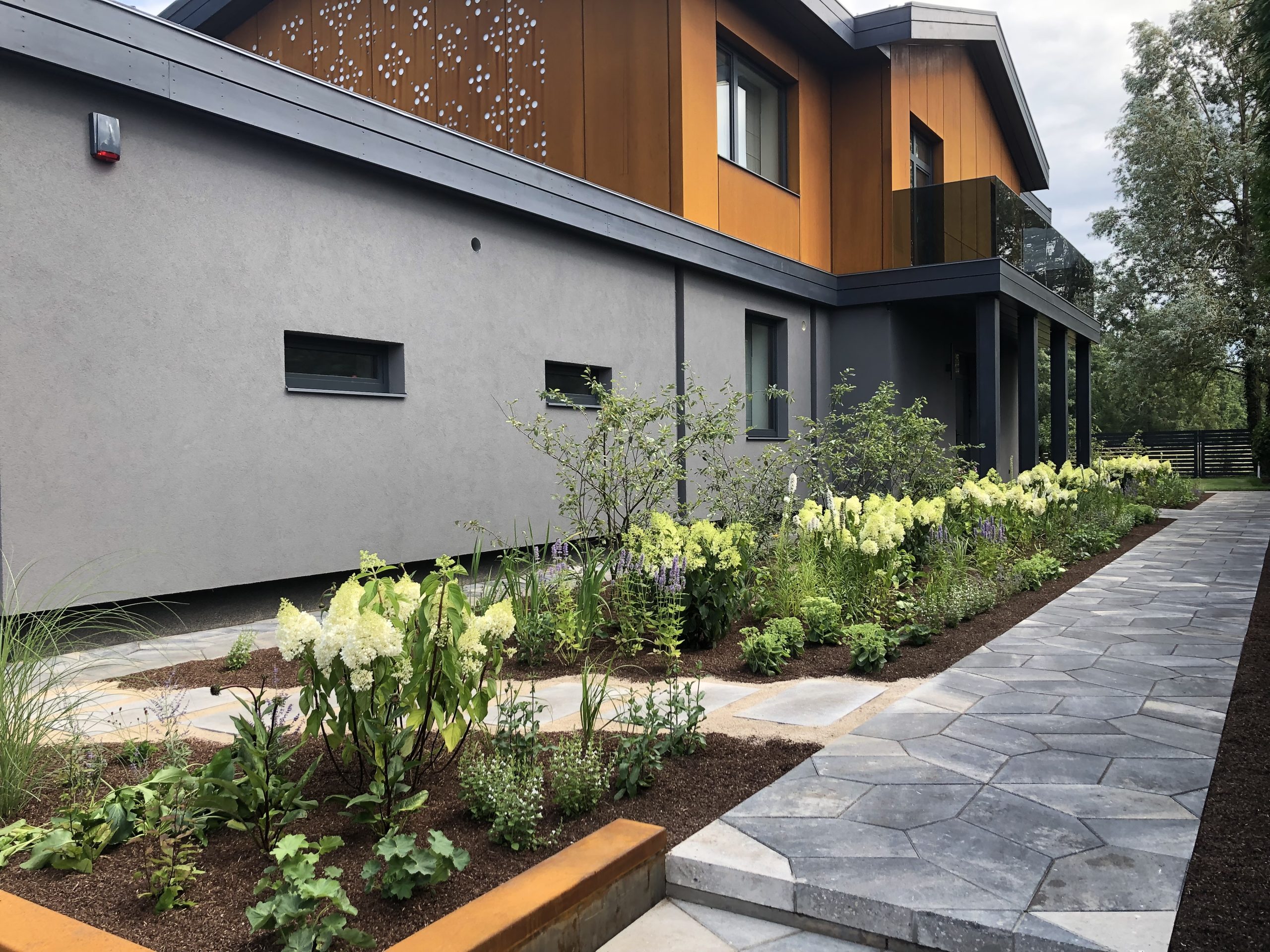 Landscaping of the garden - laid beds and paved paths.